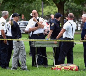 New Haven emergency personnel respond to overdose cases on the New Haven Green in Connecticut on Wednesday, Aug. 15, 2018. More than 30 people overdosed Wednesday from a suspected bad batch of “K2” synthetic marijuana at or near a city park in Connecticut. No deaths were reported, but officials said two people had life-threatening symptoms. (Arnold Gold/New Haven Register via AP)