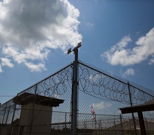 A fence stands at Elmore Correctional Facility in Elmore, Ala., June 18, 2015. Alabama inmates were in their second day of a work strike Tuesday, Sept. 27, 2022, refusing to labor in prison kitchens, laundries and factories to protest conditions in the state’s overcrowded, understaffed lock-ups. (AP Photo/Brynn Anderson, File)