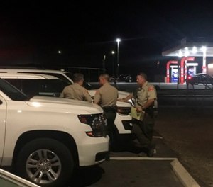Kern County Sheriff's deputies gather near the scene, Wednesday, Sept. 12, 2018, in southeast Bakersfield, Calif., where authorities say a gunman killed multiple people. (Sam Morgen/The Bakersfield Californian via AP)