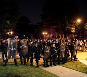 In this Sept. 15, 2017 file photo, police line up as protesters gather, in St. Louis, after a judge found Jason Stockley, a white former St. Louis police officer, not guilty of first-degree murder in the death of Anthony Lamar Smith, a black man, who was fatally shot following a high-speed chase in 2011.