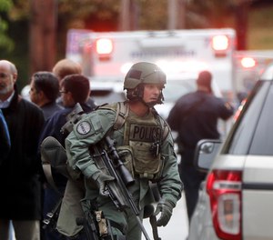 Armed police move through the streets of the Squirrel Hill neighborhood of Pittsburgh where a shooter opened fire during services at the Tree of Life Synagogue on Saturday, Oct. 27, 2018.