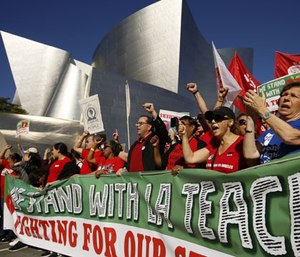 United Teachers Los Angeles leaders are joined by thousands of teachers as they march past the Walt Disney Concert Hall downtown Los Angeles.