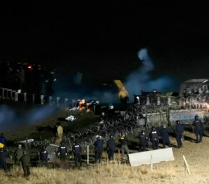 In this Nov. 20, 2016, file photo, provided by Morton County Sheriff's Department, law enforcement and protesters clash near the site of the Dakota Access oil pipeline in Cannon Ball, N.D. (Morton County Sheriff's Department via AP, File)