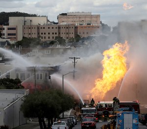 San Francisco firefighters battle a fire on Geary Boulevard in San Francisco, Wednesday, Feb. 6, 2019. The San Francisco Fire Department says several workers have been found safe after the gas explosion and fire and that no injuries have been reported.