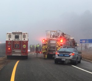 This photo provided by Virginia State Police emergency responders at the scene after a charter bus overturned on an Interstate 95 exit near Kingwood, Va., Tuesday, March 19, 2019.