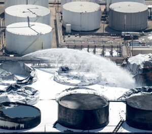 Emergency crews continue to douse what's left of the now-extinguished petrochemical tank fire at Intercontinental Terminals Company on Wednesday, March 20, 2019, in Deer Park. (Brett Coomer/Houston Chronicle via AP)