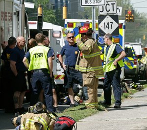 Firefighters and emergency personnel work the scene of an explosion and building fire in downtown Durham, N.C., Wednesday, April 10, 2019.