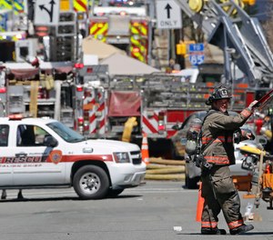 Firefighters and emergency personnel work the scene of an explosion and building fire in downtown Durham, N.C., Wednesday, April 10, 2019.