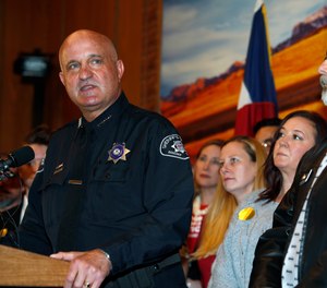 Sheriff Joe Pelle of Boulder County, Colo., speaks before Colorado Gov. Jared Polis signs a bill to allow Colorado to become the 15th state in the union to adopt a 