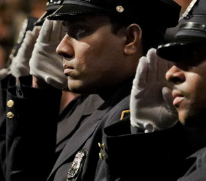 New York City Police Academy graduates salute during the national anthem at their graduation ceremony, adding 457 new members of the NYPD, Thursday April 18, 2019, in New York.