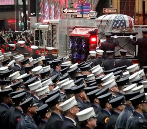 A fire truck leaves carrying the casket of U.S. Marine Corps Staff Sergeant and FDNY Firefighter Christopher Slutman, after his funeral service at St. Thomas Episcopal Church, Friday April 26, 2019, in New York. (AP Photo/Bebeto Matthews)