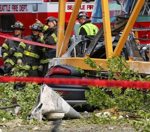 A construction crane working on a building collapsed near the intersection of Mercer Street and Fairview Avenue near Interstate 5, Saturday, April 27, 2019, in downtown Seattle. Authorities say several people have died and a few others are hospitalized after the construction crane fell onto a street pinning cars underneath Saturday afternoon. (Genna Martin/seattlepi.com via AP)