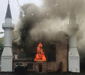 In this photo provided by Lina Biroscak, a fire burns at a mosque, Sunday, May 12, 2019, in New Haven, Conn. It was not immediately clear what caused the fire. (Lina Biroscak via AP)