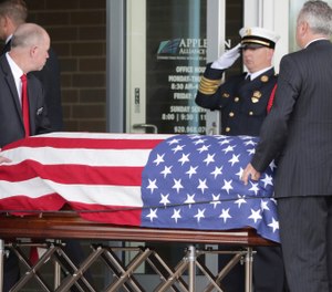 The casket of Appleton firefighter Mitchell F. Lundgaard appears at the Appleton Alliance Church on Monday, May 20, 2019, in Grand Chute, Wis. The 14-year veteran of the Appleton Fire Department was fatally shot while responding to a medical emergency at the downtown Valley Transit Center on May 15, in Appleton, Wis. (William Glasheen/The Post-Crescent via AP)