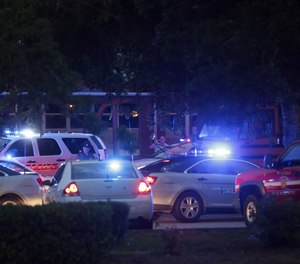 Emergency vehicles fill the parking lot at the Princess Anne Middle School in Virginia Beach, Va, on Friday, May 31, 2019. A longtime city employee opened fire at a municipal building in Virginia Beach on Friday, killing 11 people before police shot and killed him, authorities said. Six other people were wounded in the shooting, including a police officer whose bulletproof vest saved his life, said Virginia Beach Police Chief James Cervera.