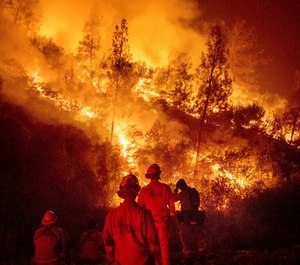 In this Aug. 7, 2018 file photo, firefighters monitor a backfire while battling the Ranch Fire, part of the Mendocino Complex Fire near Ladoga, Calif. (AP Photo/Noah Berger, File)