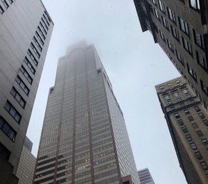 Mist and smoke cover the top of a building near 51st Street and 7th Avenue Monday, June 10, 2019, in New York, where a helicopter was reported to have crash landed on top of the roof of a building in midtown Manhattan. (AP Photo/Mark Lennihan)