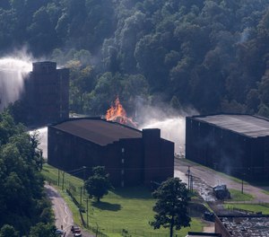 Flames and smoke rise from a bourbon warehouse fire at a Jim Beam distillery in Woodford County, Ky., Wednesday, July 3, 2019. Firefighters from four counties responded to the blaze that erupted late Tuesday. (Pat McDonogh/Courier Journal via AP)