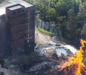 Flames and smoke rise from a bourbon warehouse fire at a Jim Beam distillery in Woodford County, Ky. (Pat McDonogh/Courier Journal via AP)