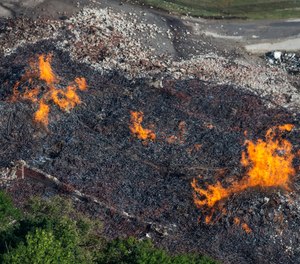 Flames and smoke rise from a bourbon warehouse fire at a Jim Beam distillery in Woodford County, Ky.
