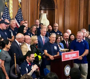 Entertainer and activist Jon Stewart, speaks at a news conference on behalf of 9/11 victims and families at the Capitol in Washington. (AP Photo/Matthew Daly)