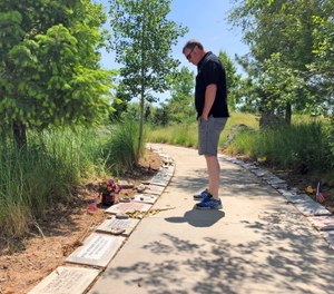 A visitor looks at memorial stones at the Wildland Firefighters Monument at the National Interagency Fire Center in Boise, Idaho. (AP Photo/Keith Ridler)