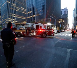 Fire trucks respond during a widespread power outage in New York City. (AP Photo/Michael Owens)