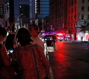 Authorities were scrambling to restore electricity to Manhattan following a power outage that knocked out Times Square's towering electronic screens and darkened marquees in the theater district and left businesses without electricity, elevators stuck and subway cars stalled.