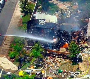This image from video provided by CBS-LA shows the aftermath of an explosion that destroyed a house in Murrieta, Calif., sending up thick flames and closing several streets.