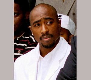 In this Aug. 15, 1996, file photo, rapper Tupac Shakur attends a voter registration event in South Central Los Angeles.
