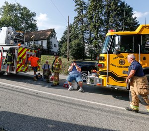 First responders rest after responding to an explosion believed to have been caused by a gas leak that reduced a western Pennsylvania home to a pile of rubble and sent several people to the hospital.