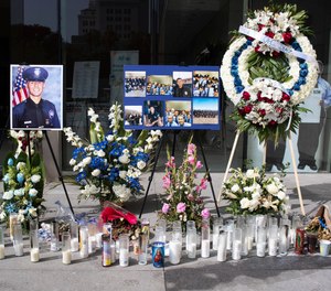 In this Wednesday, July 31, 2019 photo, a memorial for Los Angeles Police Officer Juan Diaz is on display at the Los Angeles Police Department headquarters in Los Angeles. (Sarah Reingewirtz/The Orange County Register via AP)