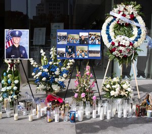 In this Wednesday, July 31, 2019 photo, a memorial for Los Angeles Police Officer Juan Diaz is on display at the Los Angeles Police Department headquarters in Los Angeles.