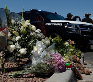 Flowers adorn a makeshift memorial near the scene of a mass shooting at a shopping complex in El Paso, Texas. (AP Photo/John Locher)