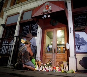 Mourners visit a makeshift memorial outside Ned Peppers bar following a vigil at the scene of a mass shooting, Sunday, Aug. 4, 2019, in Dayton, Ohio.