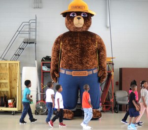 A giant Smokey Bear statue greets children at the Fire Department Open House at Fire Station One in Kinston, N.C. (Photo/Janet S. Carter, Daily Free Press via AP)