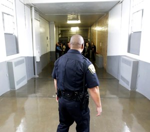 A Department of Corrections Officer walks to the Wasatch A-East block during a media tour Thursday, Feb. 26, 2015, at the Utah State Correctional Facility in Draper, Utah.