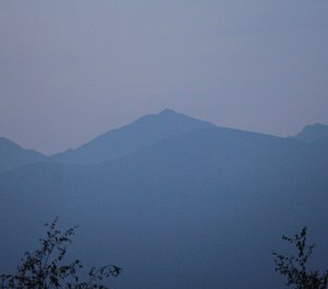 Smoke from wildfires obscure the Chugach Mountains in Anchorage, Alaska. The smoke was from two wildfires, one burning north of Anchorage and the other south. (Photo/AP by Mark Thiessen)