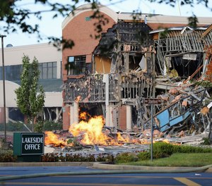 A natural gas explosion damaged a Maryland office complex and shopping center, ripping away part of the facade and exposing twisted metal.