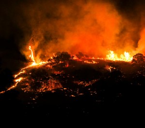 Three homes were destroyed and anther eight were impacted with fire damage. An additional 400 homes have been evacuated in the Centerville area. (Photo/Colter Peterson, The Deseret News via AP)