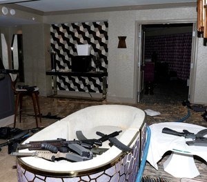 This Oct. 2017 file photo, released by the Las Vegas Metropolitan Police Department Force Investigation Team Report, shows a number of guns in the interior of mass shooter Stephen Paddock's 32nd floor room of the Mandalay Bay hotel in Las Vegas.