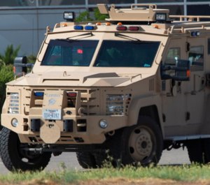 Odessa and Midland police and sheriff's deputies surround the area behind Cinergy movie theater in Odessa, Texas, Saturday, Aug. 31, 2019. (Tim Fischer/Midland Reporter-Telegram via AP)