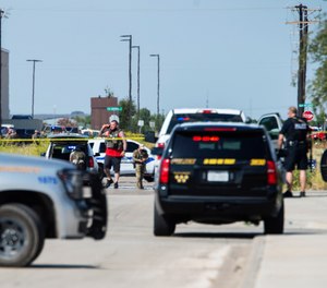 Odessa and Midland police and sheriff's deputies surround the area behind Cinergy in Odessa, Texas, Saturday, Aug. 31, 2019, after reports of shootings.