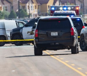 Odessa and Midland police and sheriff's deputies surround a white van in Odessa, Texas after reports of gunfire. (Photo/Tim Fischer/Midland Reporter-Telegram via AP)