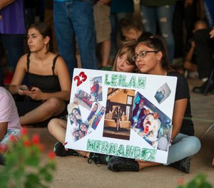 Celeste Lujan, left, and Yasmin Natera hold a sign in honor of Leilah Hernandez during a vigil for victims of the shooting spree the day before, Sunday, Sept. 1, 2019, at the University of Texas of the Permian Basin quad, in Odessa, Texas. (Jacy Lewis/Reporter-Telegram via AP)