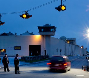 In this June 15, 2015, file photo, corrections officers watch an intersection in front of Clinton Correctional Facility in Dannemora, N.Y.