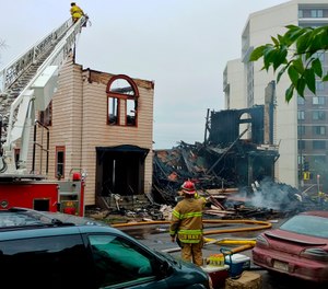 Firefighters work the scene of an overnight fire that engulfed and destroyed a synagogue in downtown Duluth, Minn., Monday, Sept. 9, 2019. (Brooks Johnson/Star Tribune via AP)