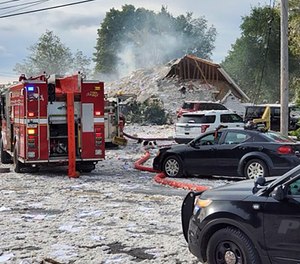 Emergency vehicles at the scene of a deadly propane explosion, which leveled new construction in Farmington, Maine.