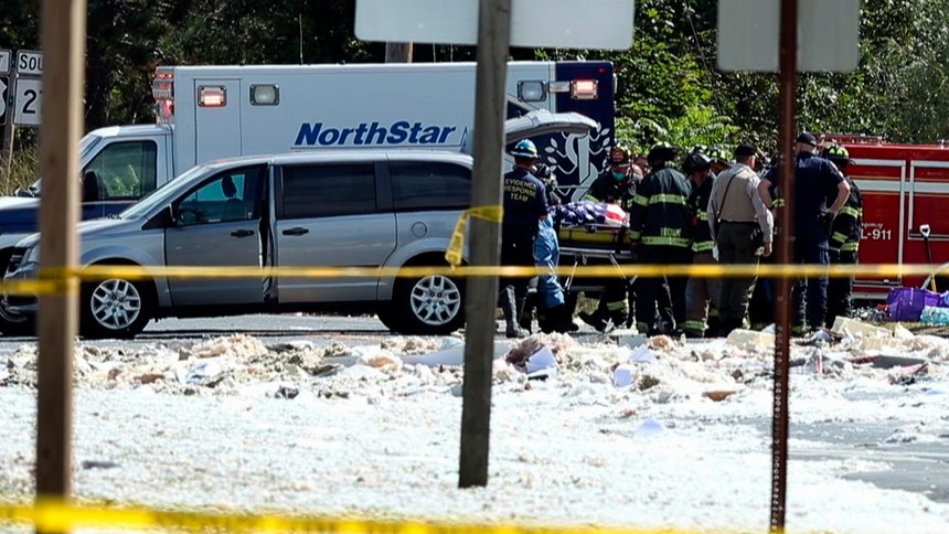In an image from video, a flag-draped body is moved to a coroner's vehicle at the scene of an explosion, Monday, Sept. 16, 2019, in Farmington, Maine. Officials say a town's fire chief is among the injured in a propane explosion that killed a firefighter. State public safety spokesman Steve McCausland said after Monday morning's explosion at a nonprofit center in Farmington that multiple people remain hospitalized.