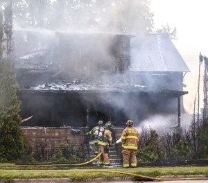 City of Fond du Lac Fire Rescue crews work a house fire Thursday, Sept. 19, 2019 in Fond du Lac, Wis. Officials say three people have died in the fire at the group home for people with disabilities. (Doug Raflik/The Reporter via AP)